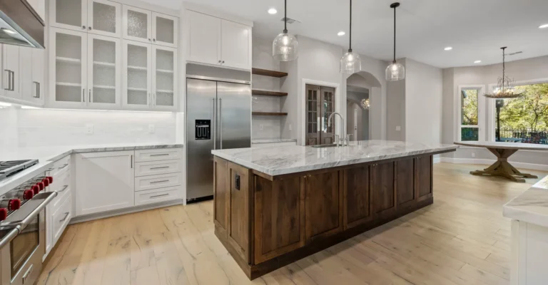 Interior of remodeled kitchen, modern with white cabinetry and countertops.